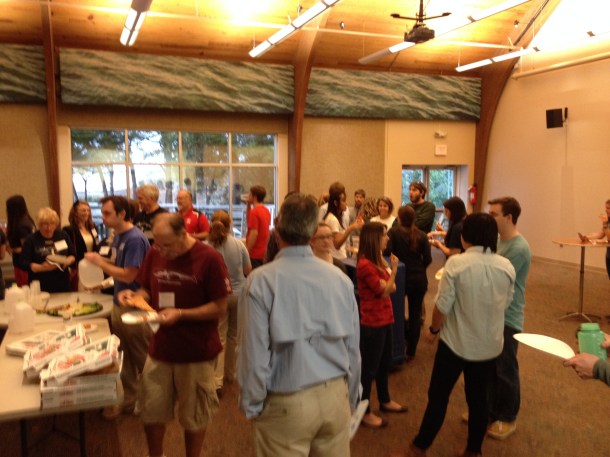 A crowd of scientists gathers for free pizza before the event