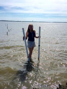 Kelsey Barnhill getting ready to launch her tide gauges. Beware of the stingrays found in that water! PC: Abbey Vinson